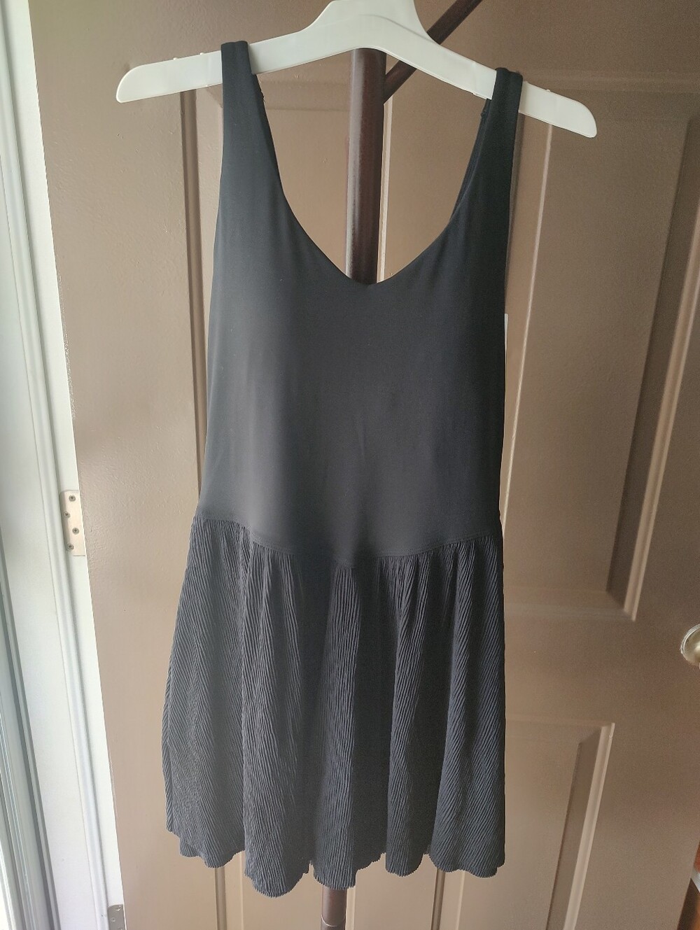 All in Motion black dress with pleated skirt and open back. Size S